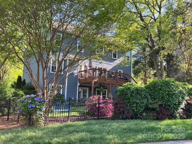3133 English Sparrow Ln, Charlotte, NC 28210 - view of front facade with fence, a wooden deck, and a front yard