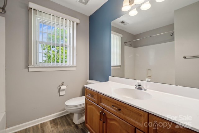 full bath featuring vanity, toilet, baseboards, wood finished floors, and visible vents