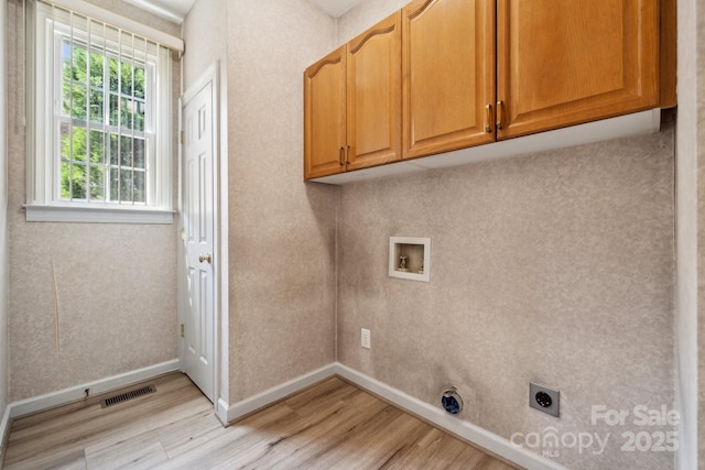 laundry room featuring cabinet space, washer hookup, light wood-style flooring, electric dryer hookup, and baseboards