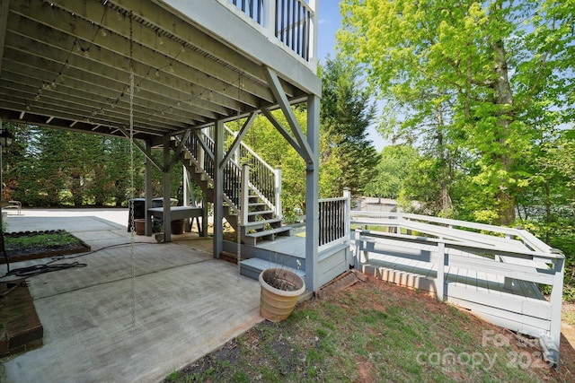 view of patio featuring fence and stairway