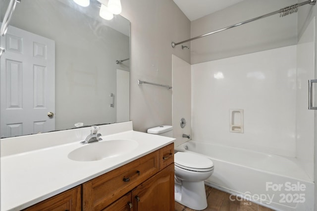 bathroom featuring vanity,  shower combination, wood finished floors, and toilet
