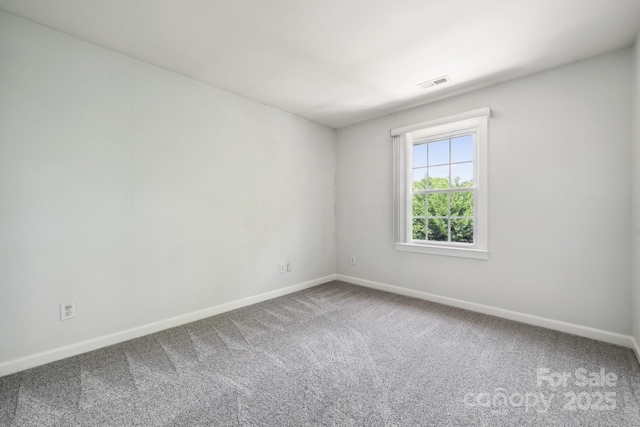 unfurnished room with baseboards, carpet flooring, and visible vents