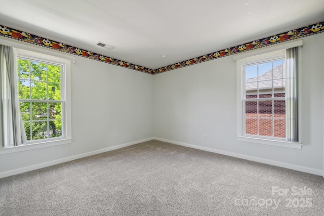 carpeted empty room with baseboards and visible vents