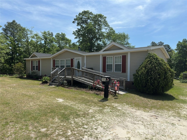 manufactured / mobile home with a deck, crawl space, and a front lawn
