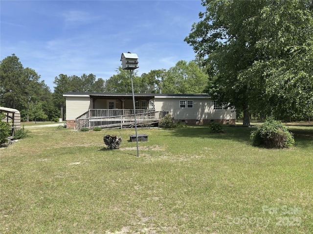 rear view of house with a lawn and crawl space