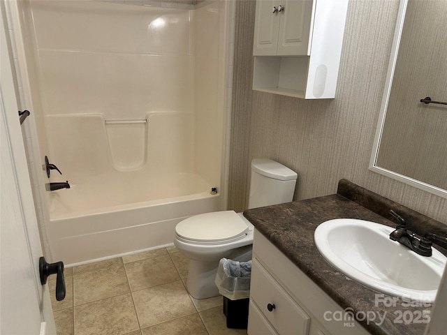 full bath featuring toilet, bathtub / shower combination, tile patterned flooring, and vanity