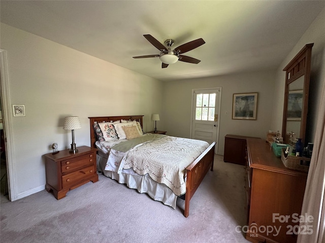 bedroom featuring baseboards, ceiling fan, and light colored carpet