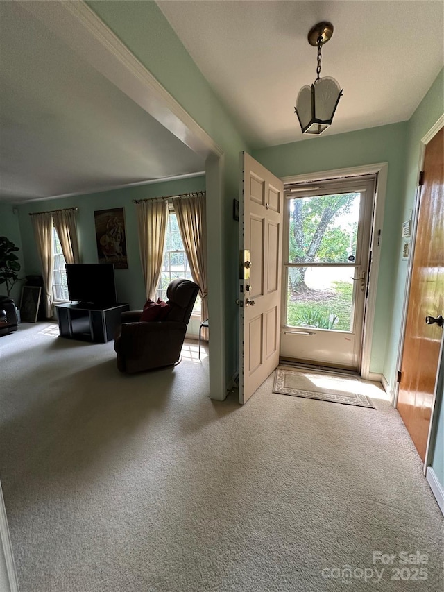 foyer entrance featuring carpet floors