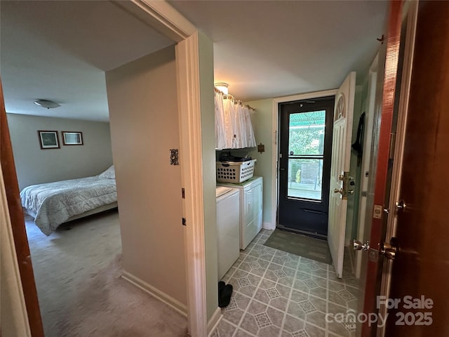 laundry area featuring cabinet space, baseboards, and washing machine and dryer