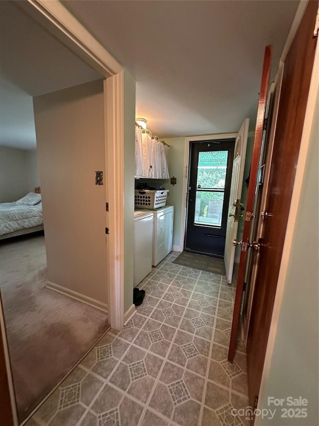laundry room featuring laundry area, washer and clothes dryer, and baseboards
