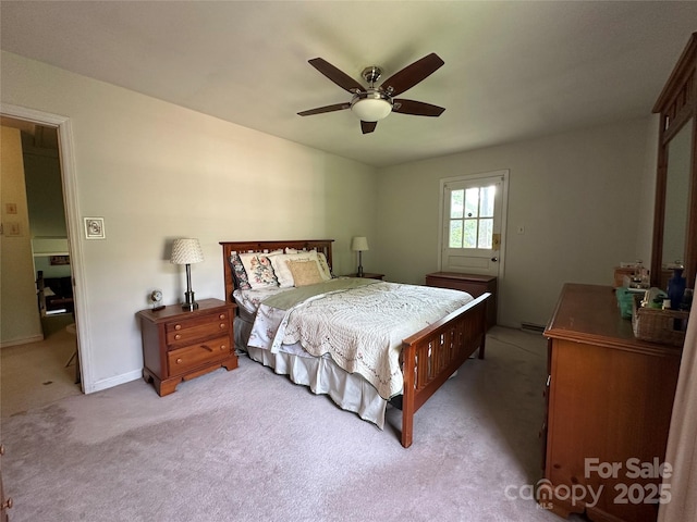 bedroom featuring baseboards, ceiling fan, and light carpet