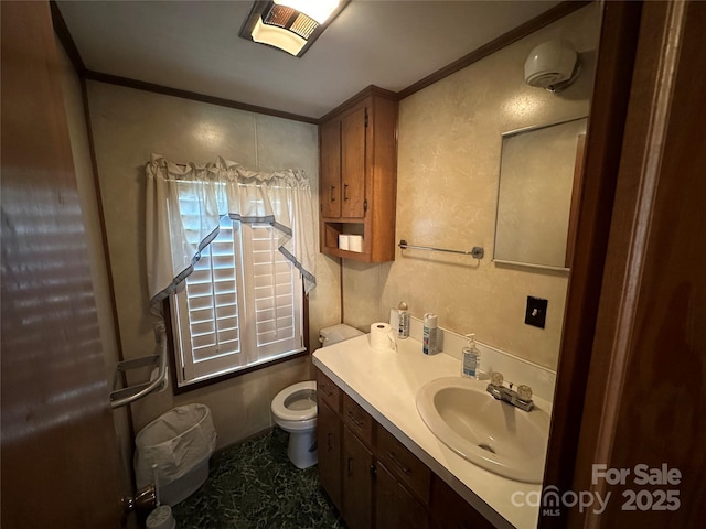 half bath featuring crown molding, vanity, and toilet