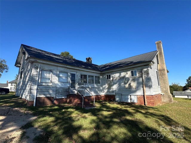 213 S Main St, Jefferson, SC 29718 - back of property with entry steps, a lawn, and a chimney