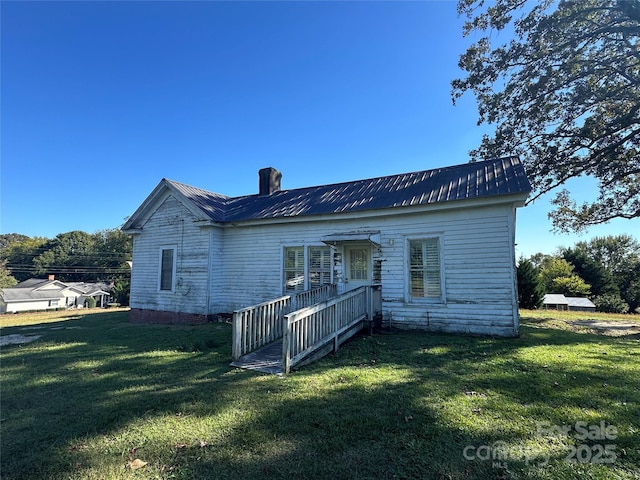 213 S Main St, Jefferson, SC 29718 - rear view of house featuring a lawn, metal roof, and a chimney