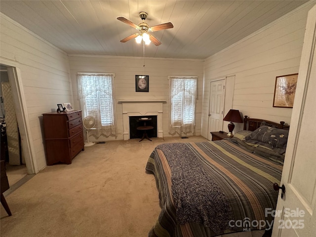 213 S Main St, Jefferson, SC 29718 - bedroom featuring light colored carpet, wooden walls, a ceiling fan, and a fireplace