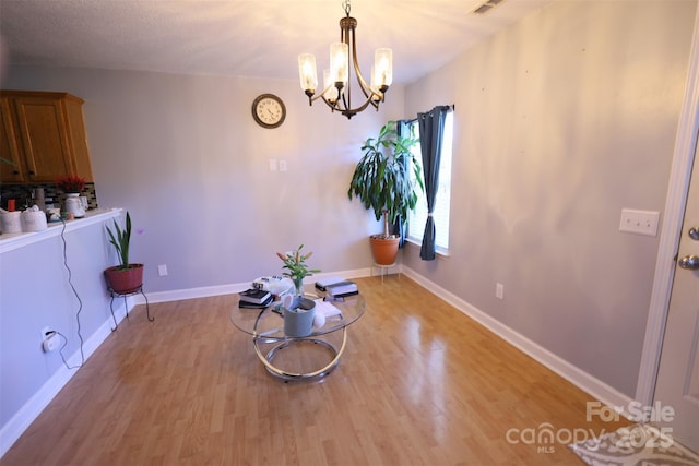 6614 Wicked Oak Ln, Charlotte, NC 28216 - unfurnished dining area with light wood-type flooring and a chandelier
