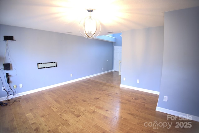 6614 Wicked Oak Ln, Charlotte, NC 28216 - spare room featuring wood finished floors and a chandelier