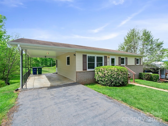 92 Church St, Weaverville, NC 28787 - single story home with asphalt driveway, a front yard, brick siding, and an attached carport