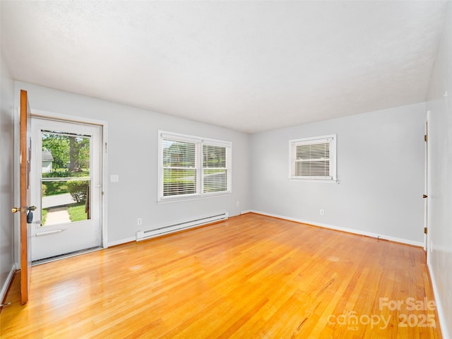 92 Church St, Weaverville, NC 28787 - unfurnished living room with baseboard heating, light wood-type flooring, healthy amount of natural light, and baseboards