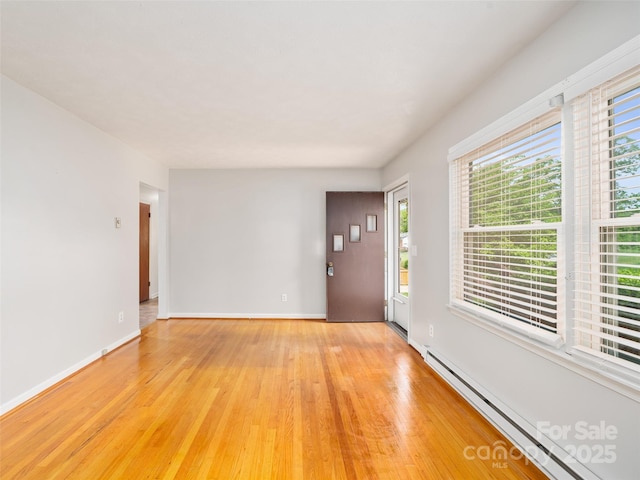 92 Church St, Weaverville, NC 28787 - foyer entrance featuring a baseboard radiator, light wood-type flooring, and baseboards