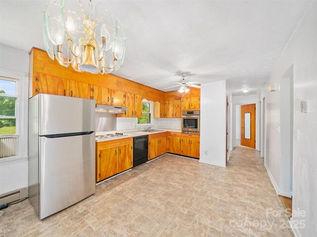 92 Church St, Weaverville, NC 28787 - kitchen with stainless steel appliances, under cabinet range hood, light countertops, a sink, and brown cabinetry