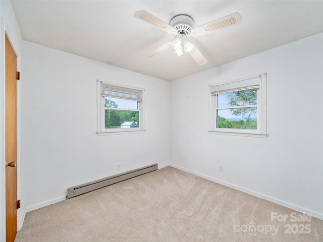 92 Church St, Weaverville, NC 28787 - spare room featuring a baseboard heating unit, healthy amount of natural light, carpet floors, and baseboards