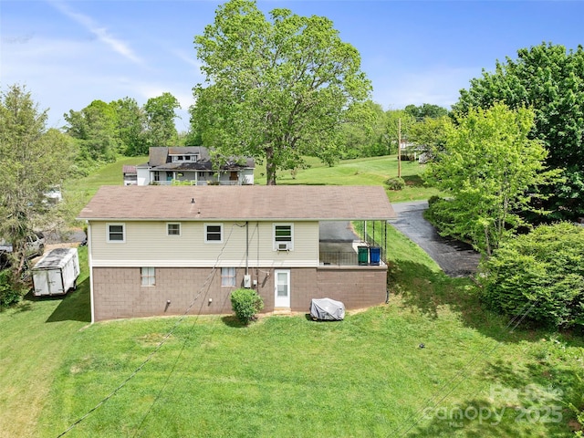 92 Church St, Weaverville, NC 28787 - rear view of house with a lawn, view of wooded area, and a storage shed