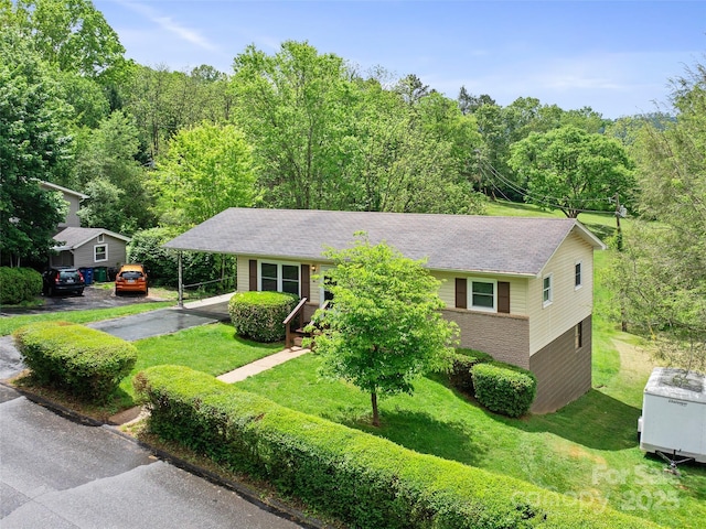 92 Church St, Weaverville, NC 28787 - view of front facade with a front lawn, a carport, driveway, a view of trees, and brick siding