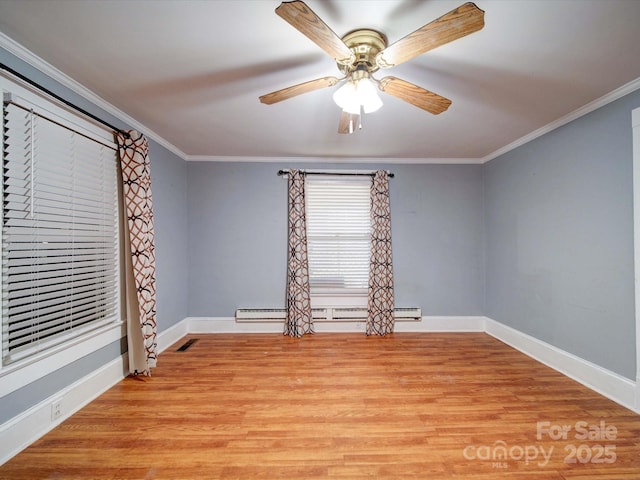 unfurnished room with light wood-style floors, crown molding, visible vents, and a baseboard heating unit