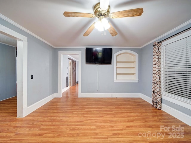 unfurnished room with ornamental molding, light wood-type flooring, built in features, and ceiling fan