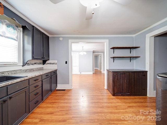 kitchen with a sink, crown molding, ceiling fan with notable chandelier, and light wood-type flooring