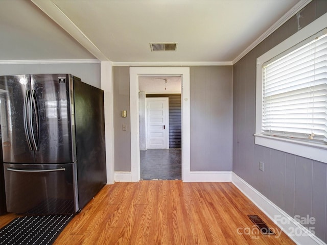 kitchen with freestanding refrigerator, baseboards, visible vents, and light wood-style floors