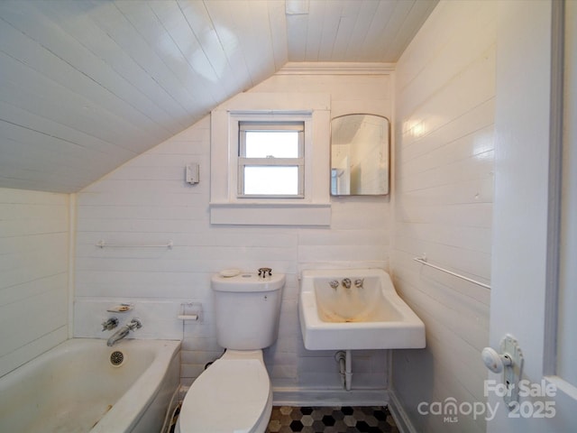 bathroom with toilet, a sink, a tub, wooden ceiling, and vaulted ceiling