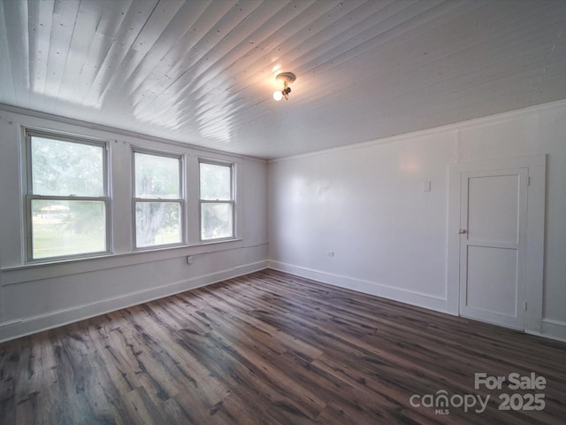 unfurnished room with baseboards, dark wood-style flooring, and wood ceiling