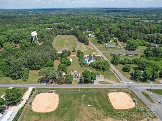 birds eye view of property with a view of trees