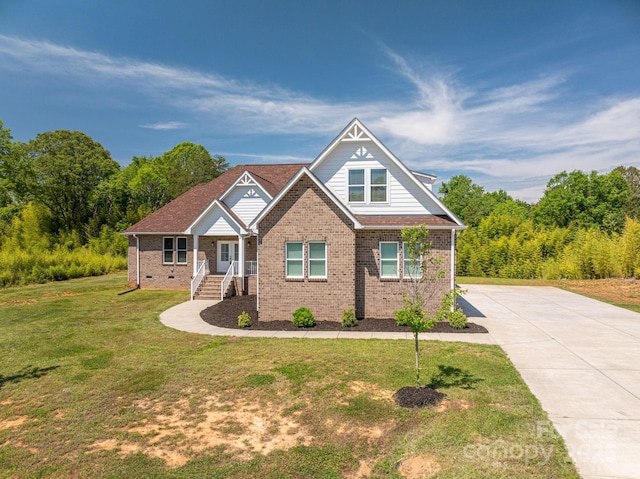 115 Woodward Way, Iron Station, NC 28080 - craftsman-style home featuring brick siding, a front yard, and driveway