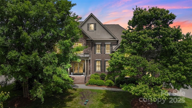 view of front of house featuring stucco siding and french doors