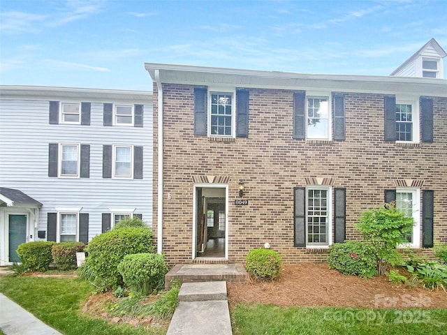 view of front of home featuring brick siding