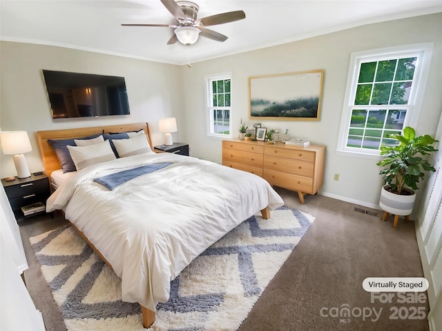 bedroom with visible vents, baseboards, crown molding, and ceiling fan