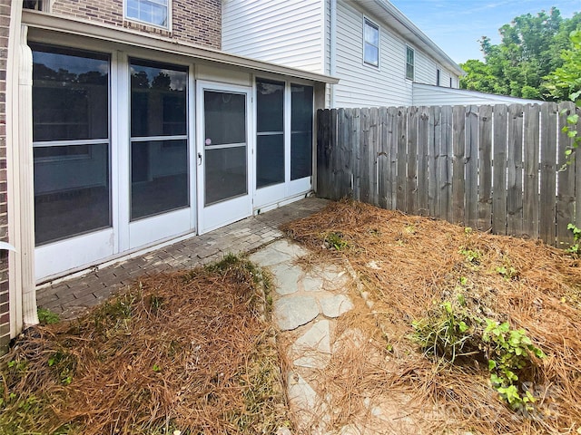 view of yard featuring a sunroom and fence