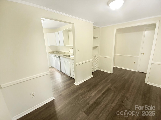 unfurnished dining area with crown molding, baseboards, dark wood-style floors, and a sink