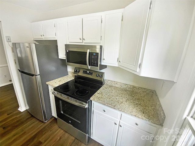 kitchen with stainless steel appliances, dark wood finished floors, white cabinetry, and light stone counters