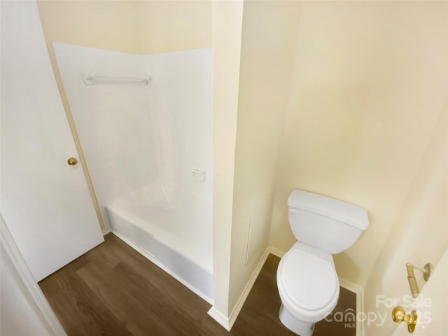 full bathroom with baseboards, wood finished floors, and toilet