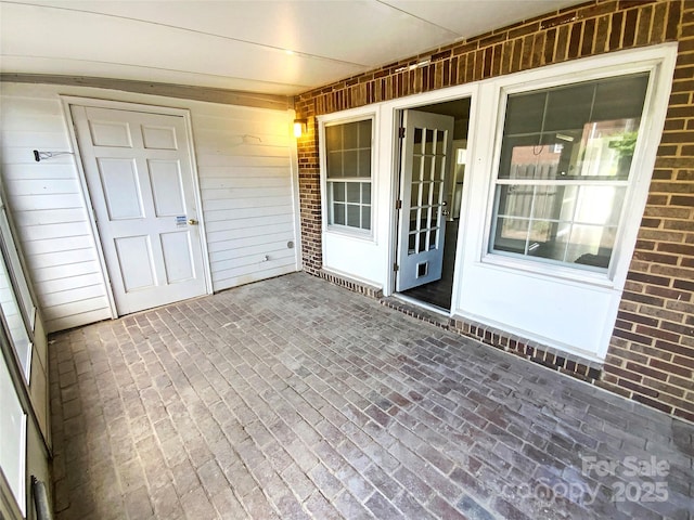 exterior space featuring brick siding