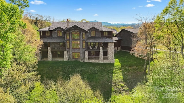 693 Thunderhill Trl, Blowing Rock, NC 28605 - rear view of property featuring a balcony, stone siding, a lawn, and a chimney