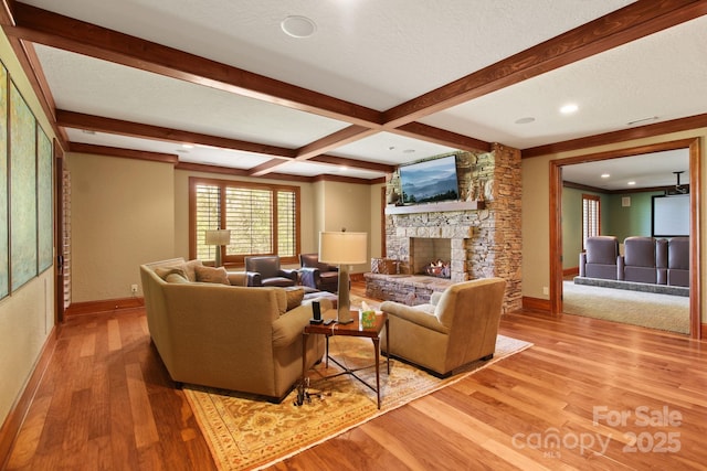 693 Thunderhill Trl, Blowing Rock, NC 28605 - living room with baseboards, light wood-type flooring, beam ceiling, a stone fireplace, and recessed lighting