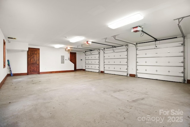693 Thunderhill Trl, Blowing Rock, NC 28605 - garage featuring a garage door opener, electric panel, and baseboards