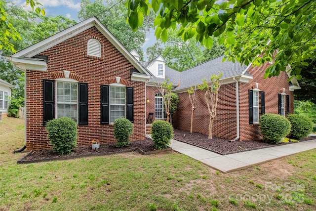 10011 Spring Park Dr, Charlotte, NC 28269 - view of front facade with roof with shingles, a front lawn, and brick siding