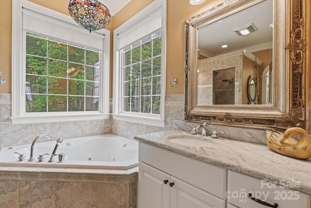 full bathroom with vanity, a tub with jets, tiled shower, and crown molding