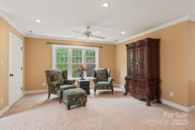 living area with light carpet, crown molding, ceiling fan, baseboards, and recessed lighting
